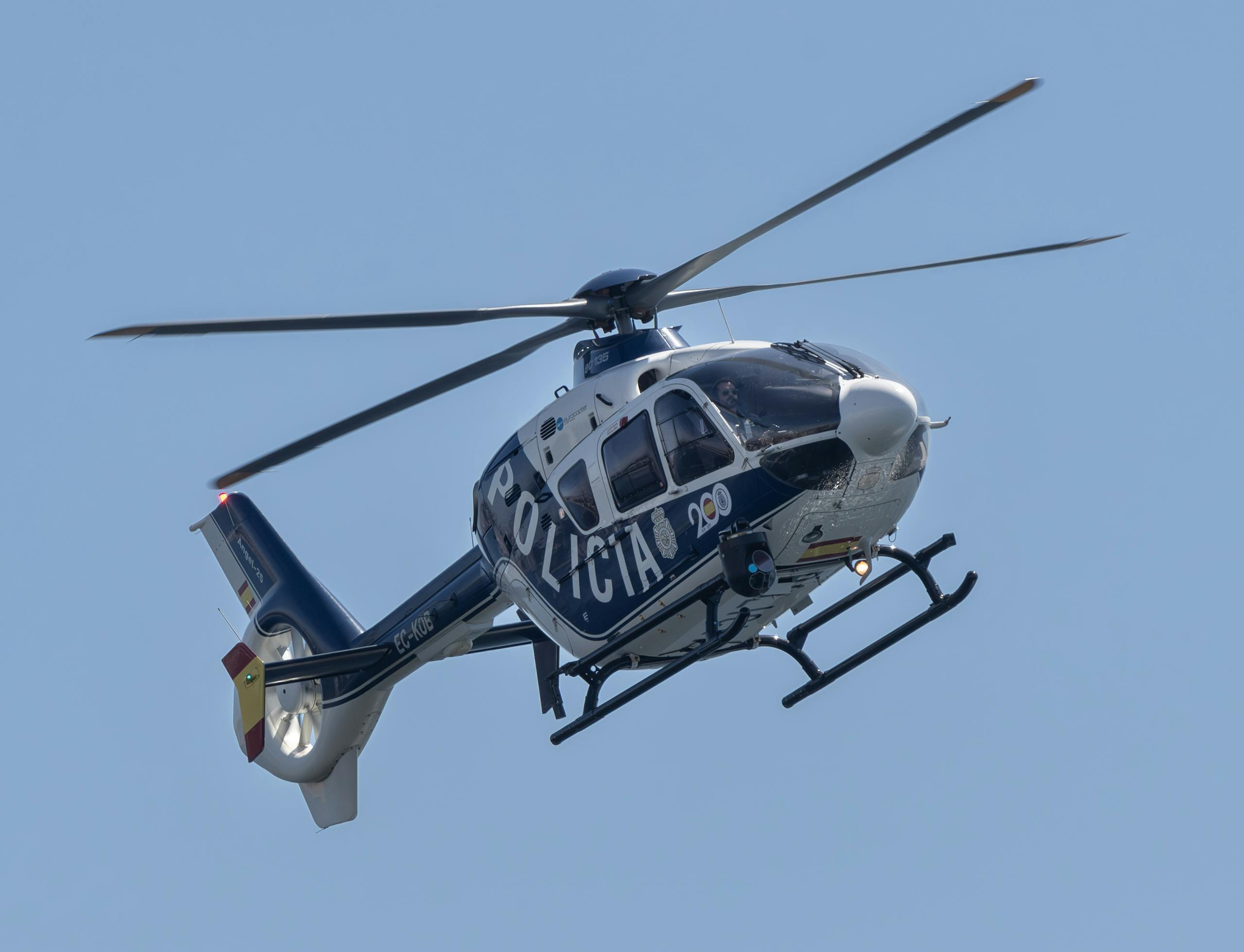 A police dog in training with officers in a snowy outdoor setting, showcasing skills and teamwork.